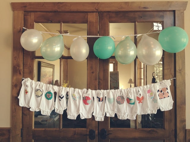 Baby shower clothesline clothespin decoration with onesies. CUTENESS!