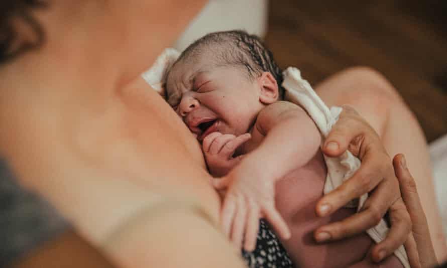 Newborn baby being held by mother
